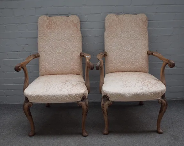 A pair of 17th century style walnut open armchairs with shaped hump back and shell capped cabriole supports, 64cm wide x 106cm high (2).