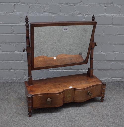 A William IV mahogany toilet mirror with brass mounted two drawer base on ring turned supports, 55cm wide x 61cm high.