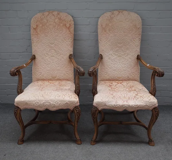 A pair of 17th century style walnut framed open armchairs on hoof feet united by shaped stretcher, 70cm wide x 114cm high (2).