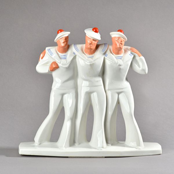 A French Art Deco style earthenware group, 20th century, modelled as three drunken sailors walking with their arms around each others  shoulders, thei