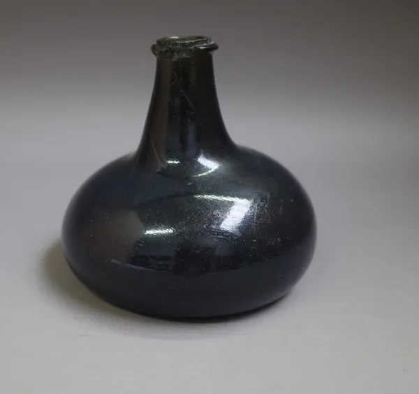 A green glass onion shaped wine bottle, probably first half 18th century, 13cm. high.