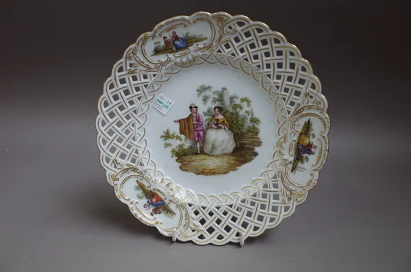 A set of six German porcelain pierced plates, possibly Meissen, late 19th century, each painted in the centre with a courting couple, inside a lattice