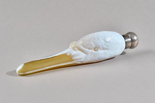 A good Thomas Webb and Sons cameo glass scent bottle, circa 1884, modelled as a swan's head in yellow glass overlaid in white and cameo cut with natur