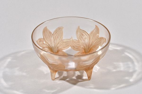 `Lys': a Lalique clear, frosted and sepia stained footed bowl, designed 1924, moulded R.Lalique, 24cm. diameter. Illustrated.  £20