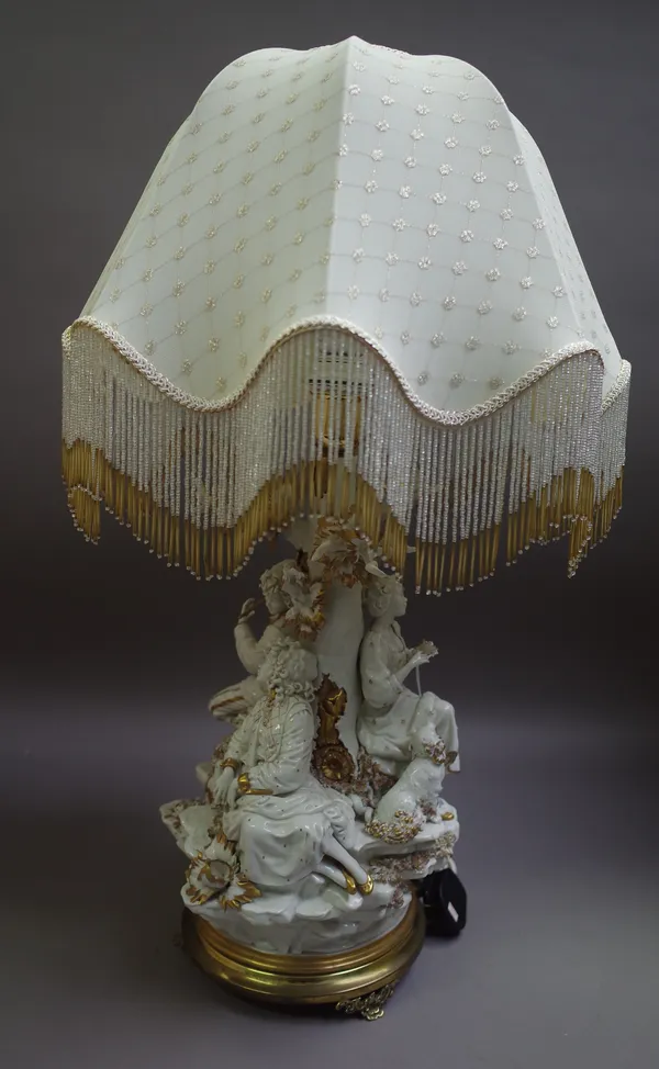 A Capodimonte porcelain figural table lamp on a gilt metal circular base and with shaped beadwork shade, blue imprinted mark, 72cm high overall.