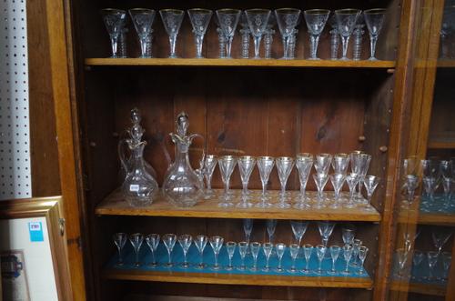 A monogrammed glass part table service, late 19th century / early 20th century, each with E.W. monogram and gilt rim, the tallest glass 19cm, (80).