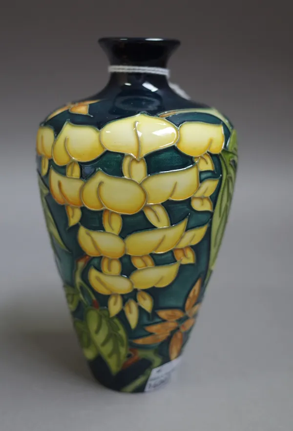 A modern Moorcroft vase, circa. 1998, foliate decorated against a green ground, printed and painted marks, 15.5cm high, boxed.