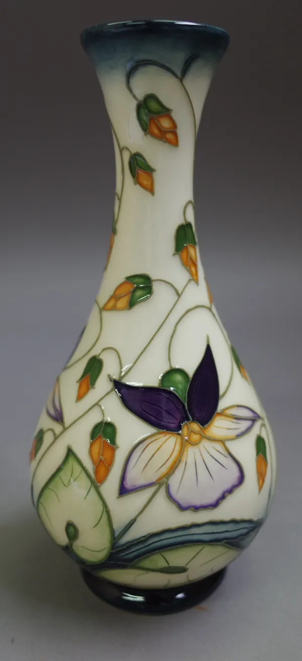 A modern Moorcroft vase by Rachel Bishop, circa. 2000, foliate decorated against a cream ground, printed and painted marks, 16.5cm high, boxed.