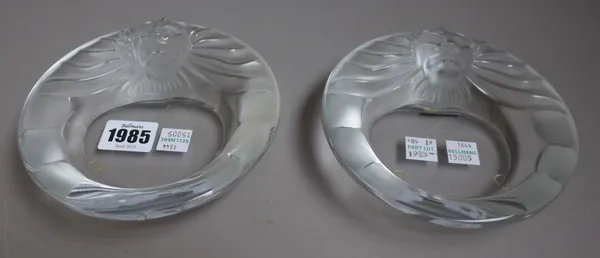 Two modern Lalique clear and frosted glass dishes, each of circular form, relief moulded with a lion's head, etched mark 'Lalique France', 14.5cm diam