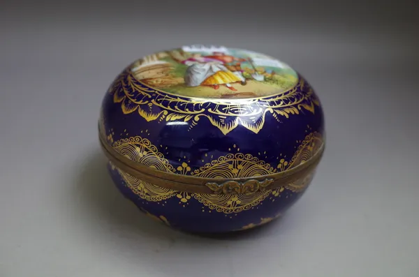 A Vienna style blue-ground gilt-metal mounted circular box and hinged cover, early 20th century, the cover painted with a gardener and companion, the