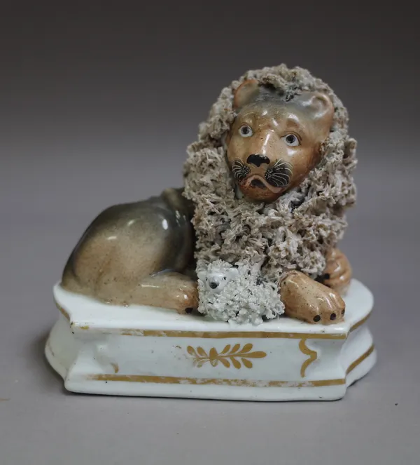 A Staffordshire porcelain group of a recumbent lion and diminutive lamb, probably Lloyd of Shelton, circa 1820, 11cm. high.