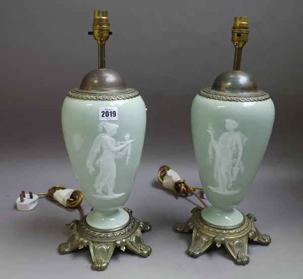 A pair of pâte-sur-pâte celadon-ground gilt-metal mounted table lamps, late 19th/early 20th century, each decorated with a classical woman, the revers