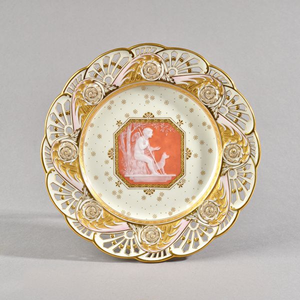 A Mintons pâte-sur-pâte pierced plate by Alboin Birks, circa 1905, decorated in the centre with a salmon-pink octagonal panel depicting a seated winge