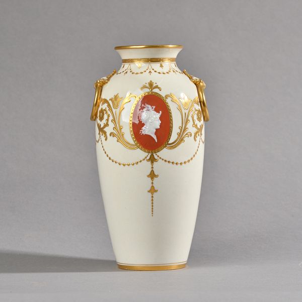 A Mintons pâte-sur-pâte vase by Alboine Birks, early 20th century, of ovoid form set with moulded acanthus and gilt ring handles, decorated with an ov