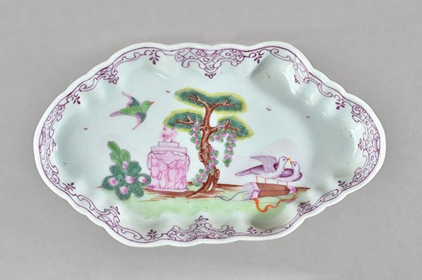 A Worcester polychrome spoon tray, circa 1760, of fluted hexagonal form, painted with the `Valentine' pattern beneath a puce scroll border, 14.5cm. wi