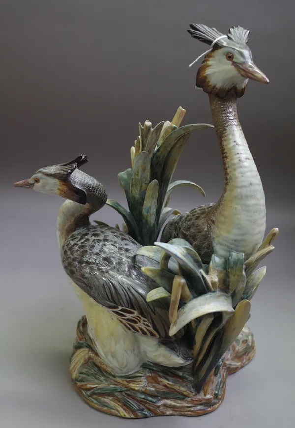 A Lladro Limited Edition ornithological group, circa 1974, modelled by Antonio Ballester as two Grebes amidst reeds guarding their eggs, coloured in p