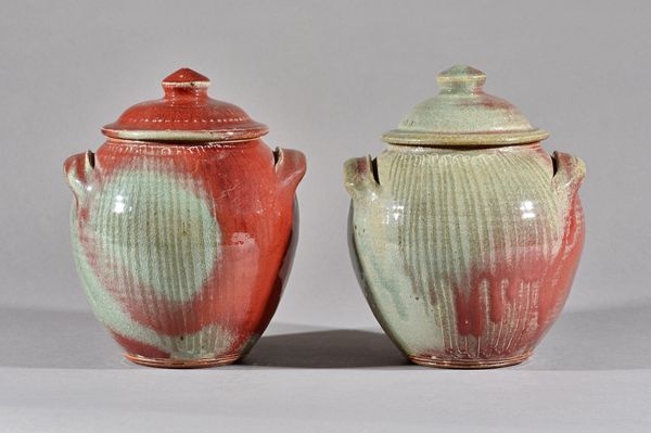 Clare Sutcliffe (1943-2019), a pair of lidded jars, incised decoration with reduced copper red glazings, makers marks, 24cm high, (2). Illustrated.