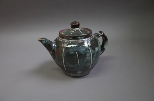 Danlami Aliyu (1952-2012), a teapot, woodfired stoneware with tenmoku chun and grass ash glazes, makers mark, 17cm high.