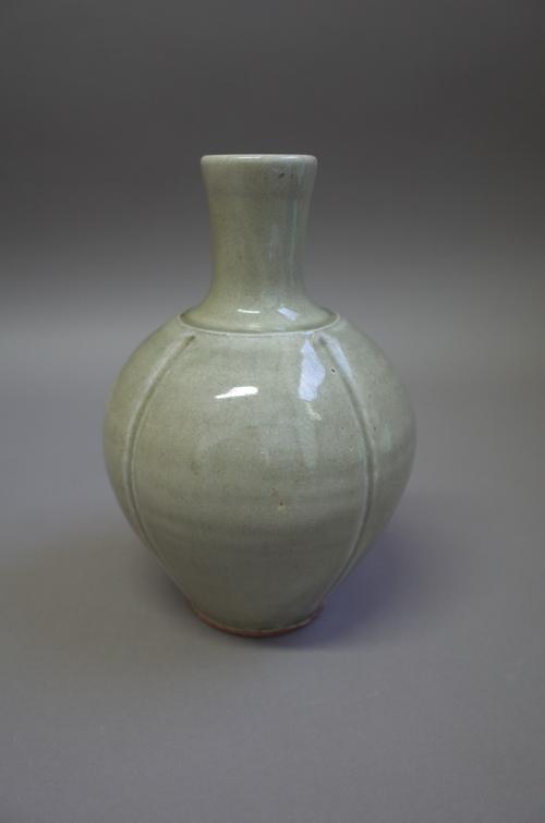 Tony Dasent (South Heighton Pottery), a vase thrown with indented walls and celadon glaze, makers mark, 23cm high.  DDS