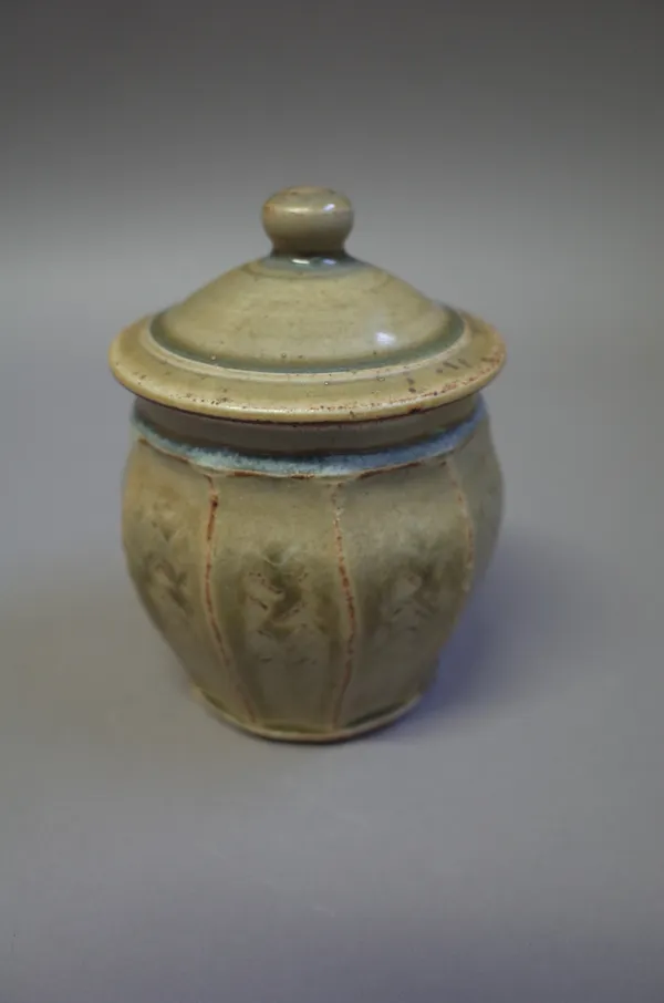 Tony Dasent (South Heighton Pottery), a lidded jar, thrown form with faceting, ash glaze, with makers and studio marks, 14cm high.  DDS