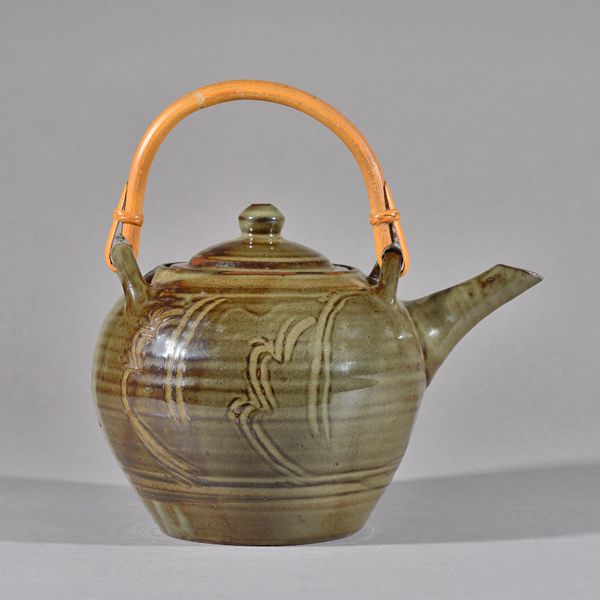 Seth Cardew (1934-2016), a large thrown teapot, incised slip under celadon glaze, maker and Wenford Brdige marks, 19cm high.  DDS Illustrated.