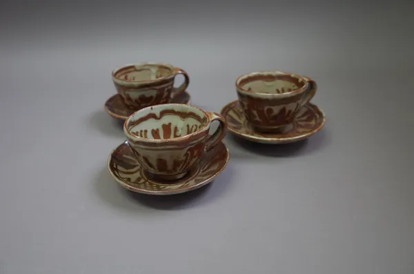 Seth Cardew (1934-2106), three cups and saucers, rich iron brushwork, maker and Wenford Bridge marks, (one cup a.f.)cup 7cm high.  DDS