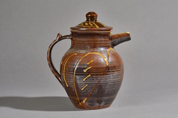 Seth Cardew (1934-2016), a lidded jug with tenmoku over slip decoration, maker and Wenford Bridge marks, 21cm high.  DDS Illustrated.