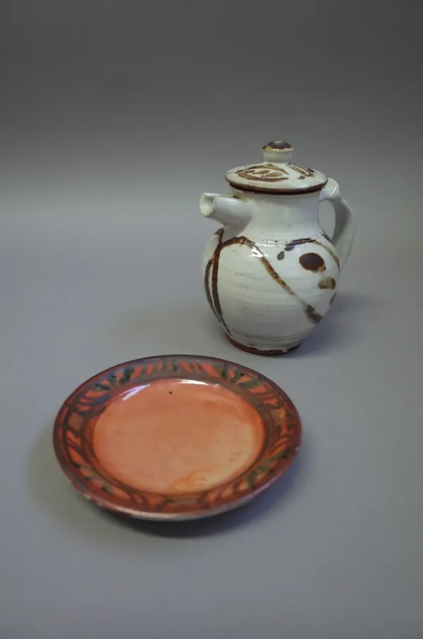 Seth Cardew (1934-2016), a lidded jug with iron brushwork design together with a small plate decorated in rich orange finish, maker and Wenford Bridge