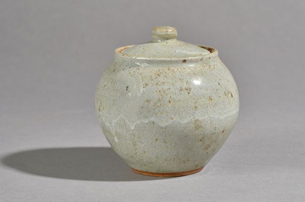 Ursula Mommens, a small stoneware jar with celadon glaze with makers mark, 11cm high.  DDS Illustrated.