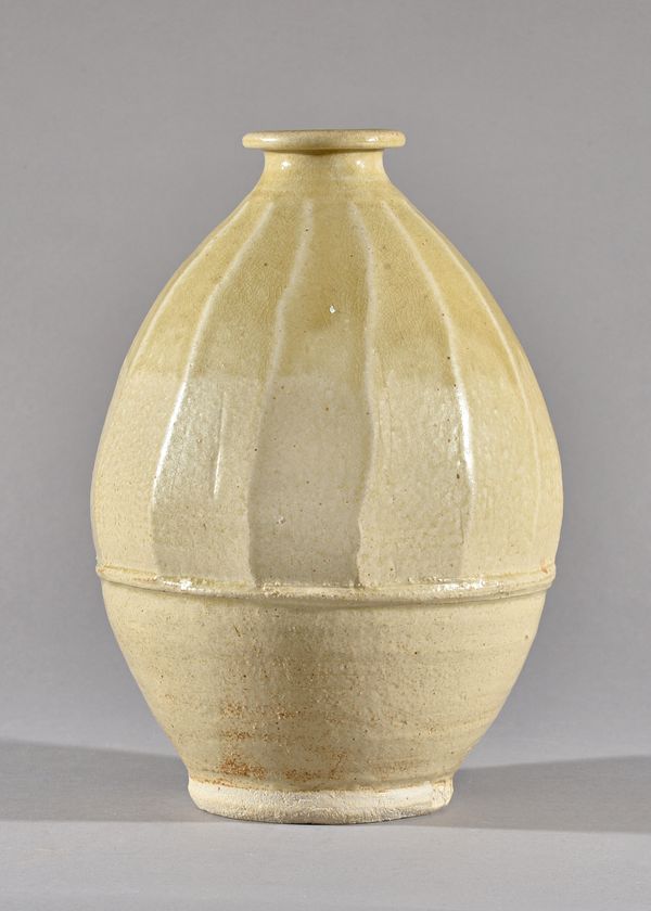 Jim Malone (born 1946), a thrown and shaped form with celadon glaze, maker and studio marks, 30cm high.  DDS Illustrated.