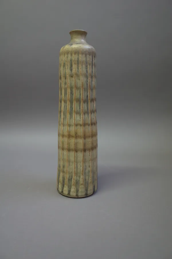 A tall bottle vase, thrown form with faceting, ash glaze, makers mark, 33cm high.