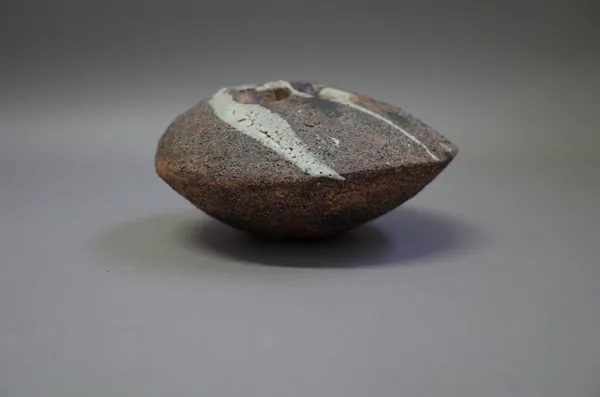 Robert Fournier (1915-2008), a pebble form with mottled brown glazes over a tetured surface with iron, makers mark, 16cm long.  DDS