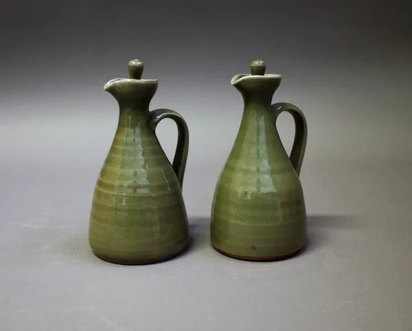 Harry & May Davis, (1910-1986 & 1914-1998), a pair of oil bottles with stoppers, stoneware with celadon glaze, with makers mark CP, 14cm high, (2).  D