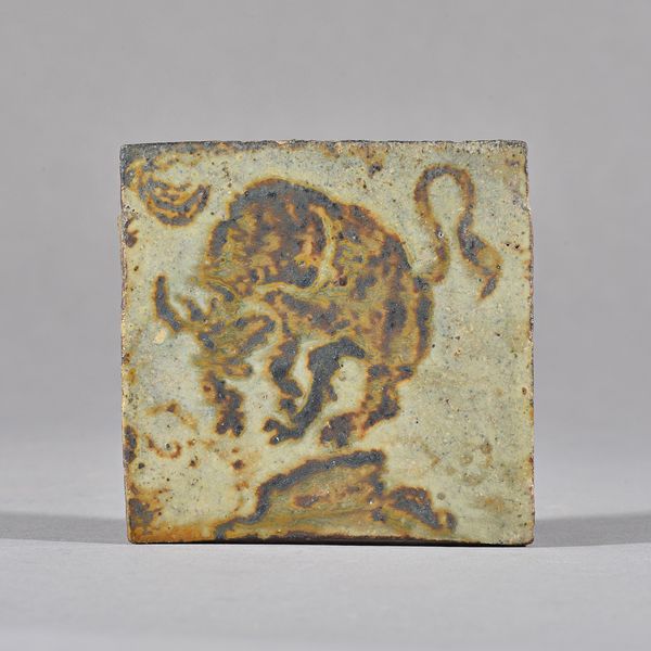 Attributed to Bernard Leach, a tile, decorated with a bull under sickle moon, brush worked iron under ash glaze, 9cm square. Illustrated.