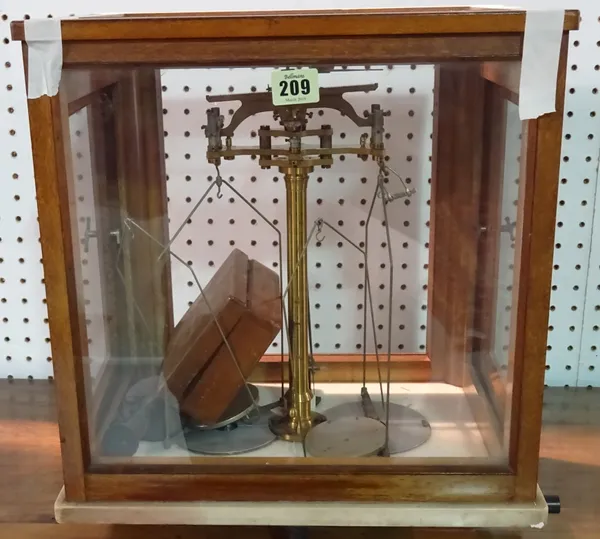 An early 20th century mahogany cased set of chemist's balance scales.