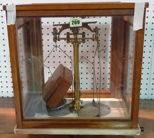 An early 20th century mahogany cased set of chemist's balance scales.