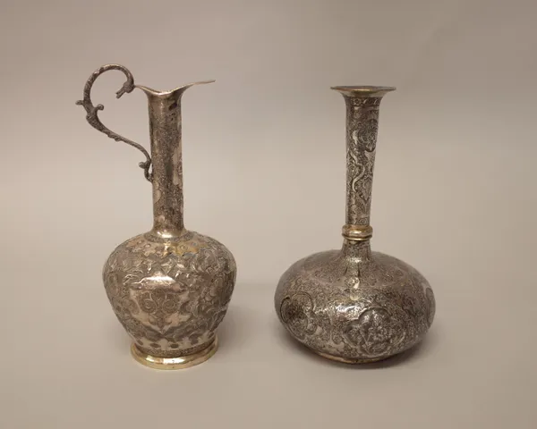 Persian wares, comprising; a jug with embossed and engraved floral decoration, height 18.5cm and a bottle vase, decorated with floral and foliate pane