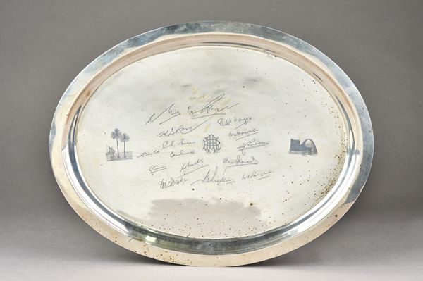 A Persian oval serving dish, niello decorated to the centre, with a monogram surrounded by facsimilie signatures, otherwise decorated with two palm tr