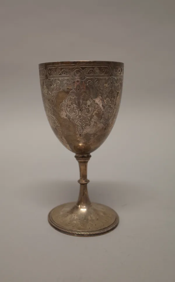 A Victorian silver cup, with feathered scroll engraved decoration, raised on a trumpet shaped circular foot, decorated with reeded bands, presentation