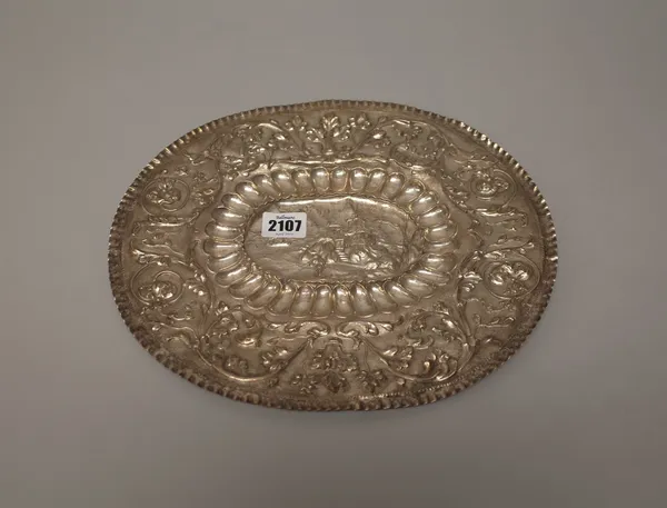 An Eastern European oval salver of panel shaped form, embossed with a castle and a ship to the centre in a lobed border and with a wide rim, embossed