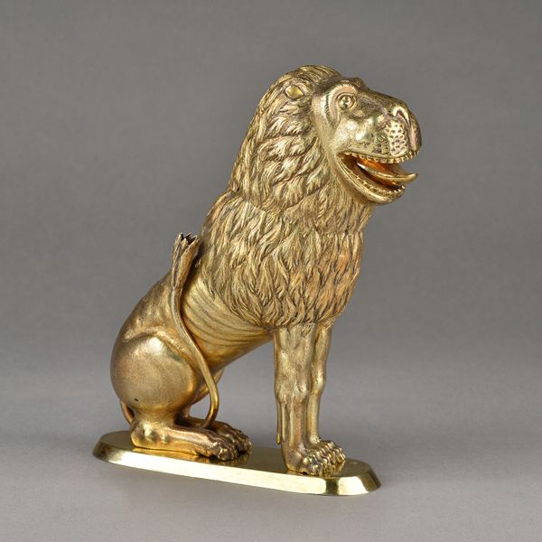 A German model of a gilt seated lion, the detachable head revealing a hollow interior, raised on a possibly later oval base, possibly Altenburg 18th c