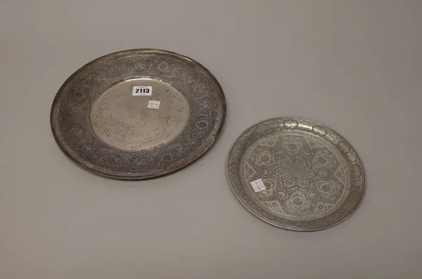 Persian wares, comprising; a circular dish, undecorated to the centre, the wide rim engraved with floral motifs within panels, diameter 27cm and a sma