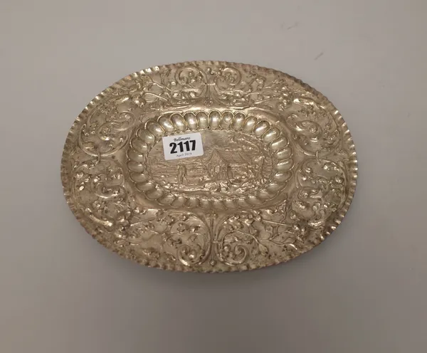 An Eastern European oval salver of panel shaped form, embossed with a cottage with a figure in a landscape scene to the centre in a lobed border and w