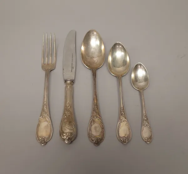 A German part table service of flatware, comprising; nine tablespoons, nine dessert spoons, seven table forks, eight teaspoons and eleven steel bladed