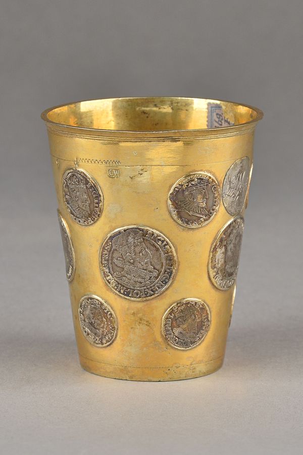 A European gilt beaker, of tapering cylindrical form, mounted with various mostly Polish coins, 16th and 17th century dates, height 9.7cm, gross weigh