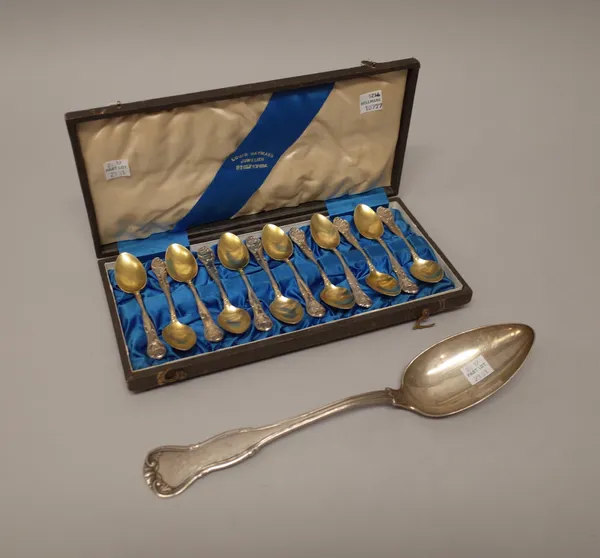 German flatware, comprising; a set of twelve parcel gilt coffee spoons, cast with scrolling decoration, engraved with coronets and monograms, with a f