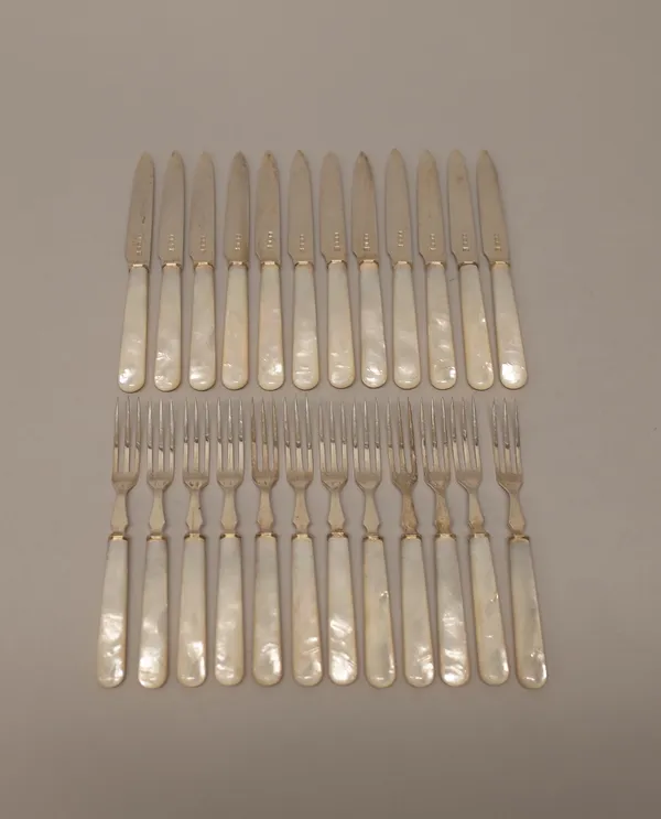 A set of twelve pairs of silver and mother-of-pearl dessert or fruit knives and forks, with silver blades and prongs and with mother-of-pearl handles,