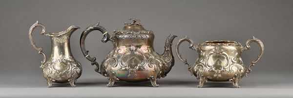 A Victorian silver three piece tea set, comprising; a teapot, a twin handled sugar bowl and a milk jug, each piece of bombe form, with floral, foliate