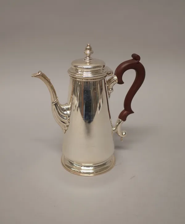 A silver coffee pot, of tapering cylindrical form, on a circular foot, with a brown composition handle, in the 18th century taste, Birmingham 1971, co