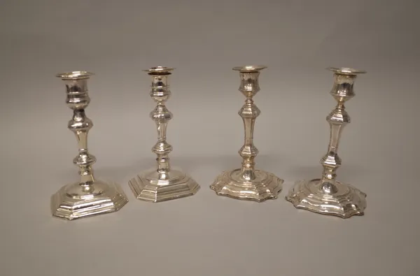 A pair of silver table candlesticks, each with a knopped stem, raised on a cut cornered square base, the hallmarks rubbed, height 18.5cm and a pair of